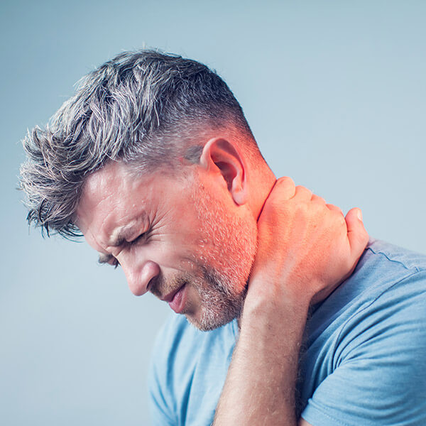 man holding neck in pain